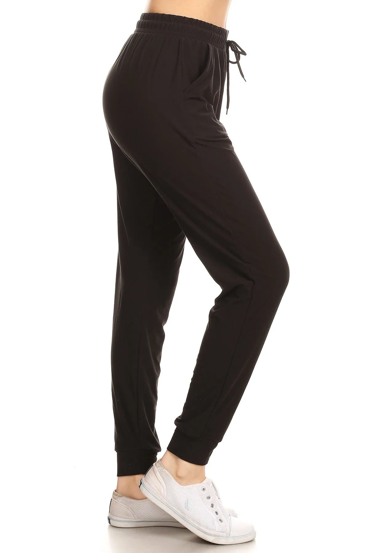 Solid color joggers with solid trim, drawstring waistband, waist pockets, and cuffed hems - Black